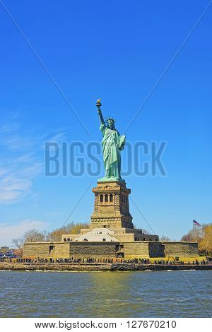 Statue on Liberty Island New York City USA. In Upper New York Bay. Tourists are walking on the island.