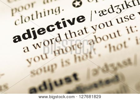 Close Up Of Old English Dictionary Page With Word Adjective.