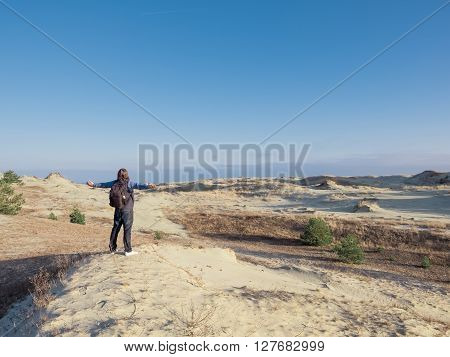 Happy man on beach spring holiday in cheerful bliss enjoying the sunshine with arms outstretched