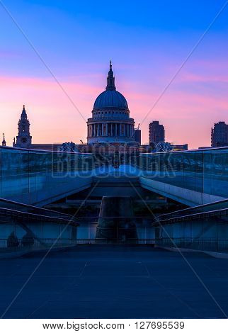 View of purple sunset at St Paul's Cathedral and the Millennium Bridge in London