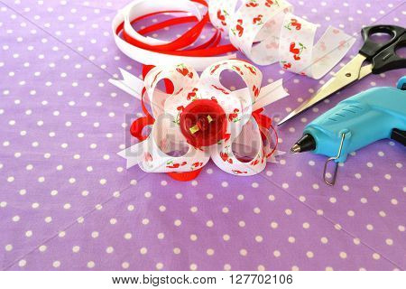 Bright bow of ribbon, children hair accessory, ribbon set, scissors, hot glue gun