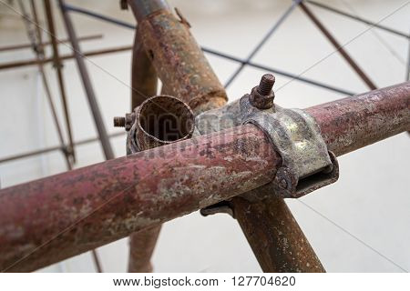 Metal scaffolding rusty joint coupler in a construction site