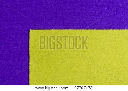 Eva foam ethylene vinyl acetate lemon yellow surface on purple sponge plush background