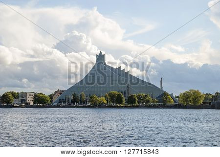 RIGA, LATVIA - JULY 20: Modern building of national library in Riga Latvia at waterfront against of cloudy sky. July 2015