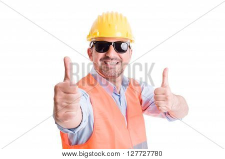 Happy contractor or builder showing thumbsup and wearing shades or sun goggles