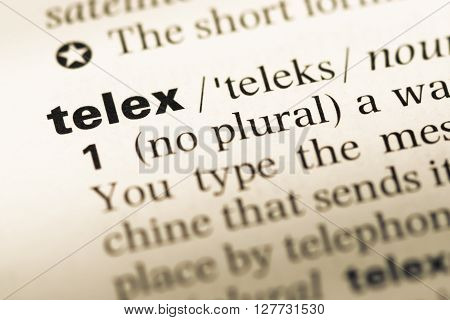 Close Up Of Old English Dictionary Page With Word Telex.