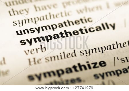 Close Up Of Old English Dictionary Page With Word Unsympathetic.