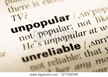 Close Up Of Old English Dictionary Page With Word Unpopular.