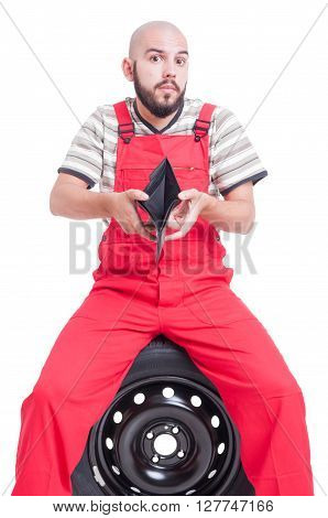 Broke and poor mechanic showing empty wallet as bankruptcy concept