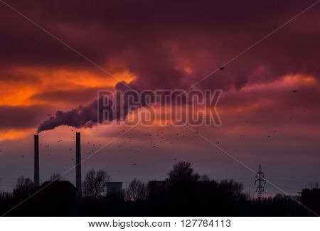 Industrial cityscape with coal power plant and smoke stacks
