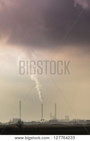 Industrial cityscape with coal power plant and smoke stacks