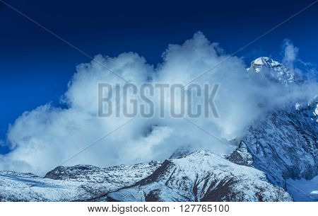 Dramatic sea of clouds and snow covered peaks in Himalaya