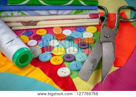 background with sewing accessories, with colored chintz, buttons, shears, set for needlework