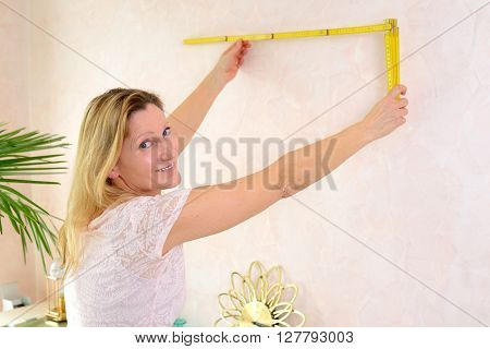 Woman Redecorate Home And Working With Folding Yardstick