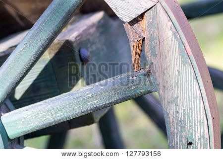 fragment of a big wooden wheel with spokes for an ancient cartage and for the cart or the vehicle