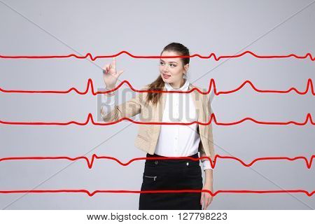 Doctor woman working with cardiogram lines