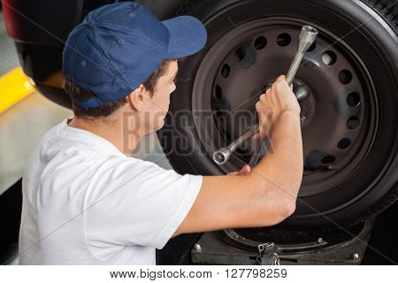 Mechanic Fixing Car Tire