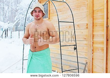 Man after bathhouse in winter in nature