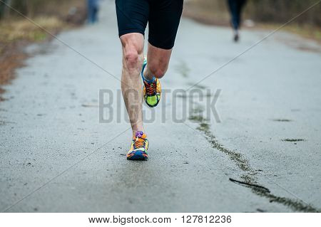 closeup feet of young runner men running along road in Park during marathon. front view
** Note: Soft Focus at 100%, best at smaller sizes
