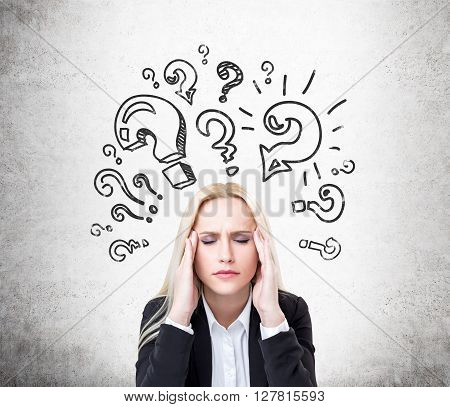 Research concept with stressed businesswoman and question mark sketch on concrete wall