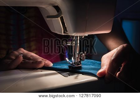 Close up of sewing machine on the table in the night.