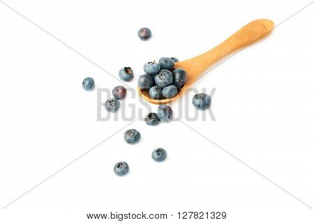 Wooden spoon filled of Ripe bilberry or blueberry over isolated white background