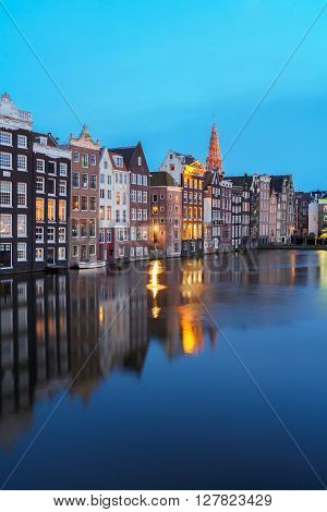 Houses over canal with mirror reflections at night, Amstardam, Netherlands