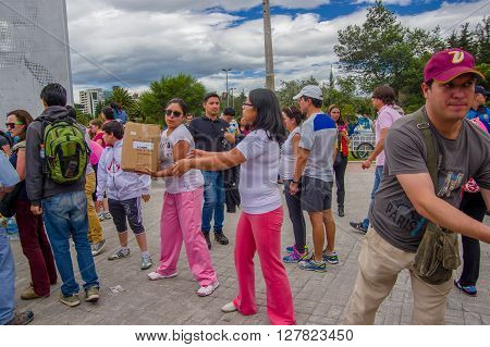 Quito, Ecuador - April, 17, 2016: Unidentified citizens of Quito providing disaster relief food, clothes, medicine and water for earthquake survivors in the coast.