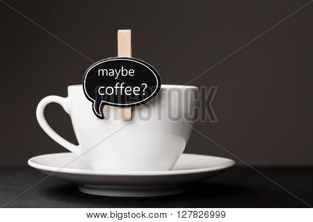 White cup of morning coffee with black thought cloud for messege on it.