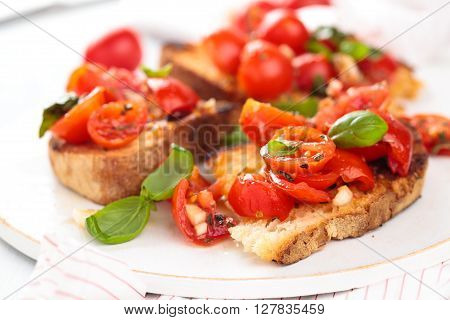 Delicious Italian bruschetta with cherry tomatoes basil and garlic.