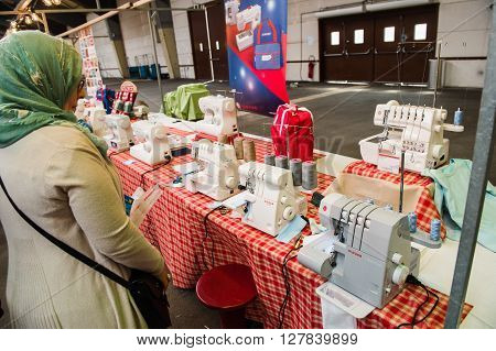 Muslim Woman Looking At Sewing Machines