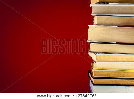 A Pile Of Books On Colored Background