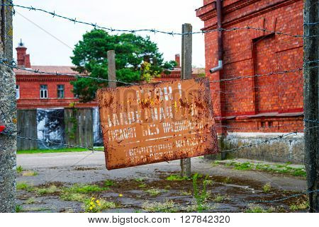 Sign Board With Warning On Russian At Prison Entrance