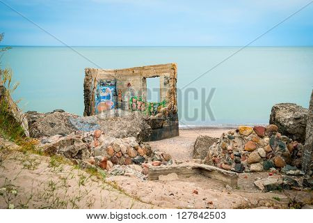LIEPAJA, LATVIA - AUGUST 2: View on ruined building on Liepaja beach against of endless waterscape Latvia. August 2015
