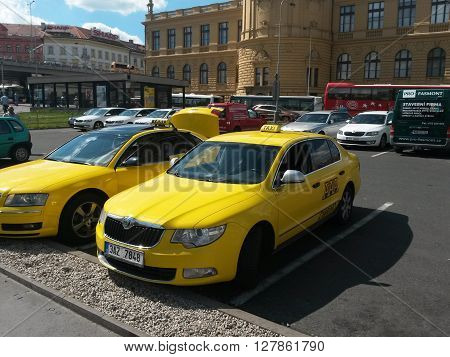 PRAGUE CZECH REPUBLIC - CIRCA JUNE 2015: yellow taxi cars parked on a street in the city centre