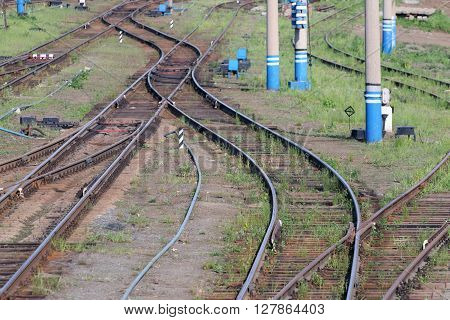Railways with wooden sleepers poles grass and turnouts at summer