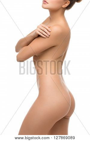 Beautiful naked fit young woman body. Isolated over white background. Copy space.