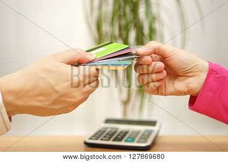 young couple in debts woman choosing credit card for spending