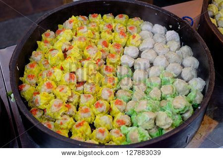 Traditional Chinese dumplings called "Dim Sum" steamed in the wooden containers.