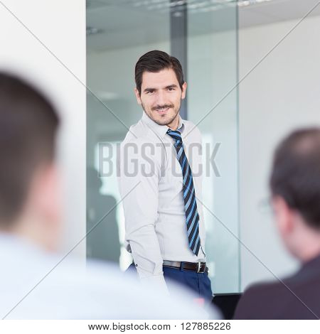 Relaxed cheerful team leader and business owner leading informal in-house business meeting. Business and entrepreneurship concept.