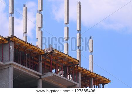 Part of concrete residential building on construction site and blue sky at sunny day