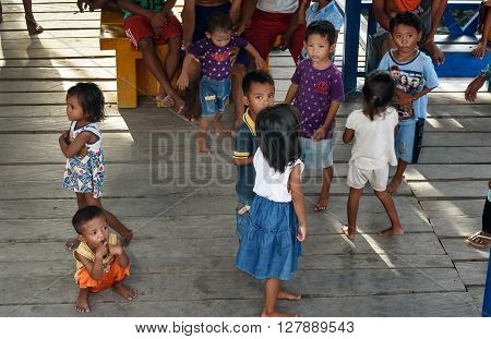 Indonesian Children On The Pier In Tobil Village Togean Islands