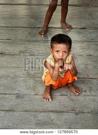 Indonesian Children On The Pier In Tobil Village Togean Islands