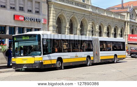Schaffhausen, Switzerland - 26 August, 2015: people entering a bus standing on the bus stop on Bahnhofstrasse street at the Schaffhausen train station. Shaffhausen is a city in northern Switzerland and the capital of the canton of Schaffhausen.