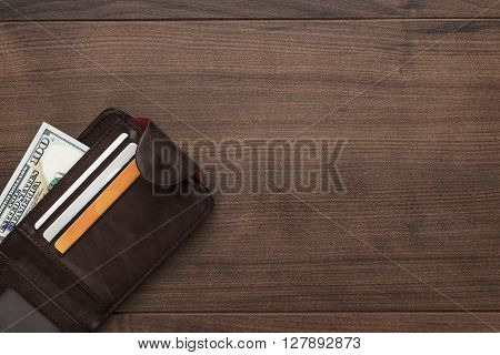 men's purse with money, credit and debit cards on the wooden table