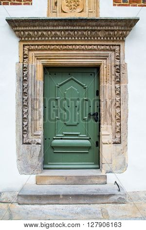 Old green wood doors, portico stoa and one step stairs