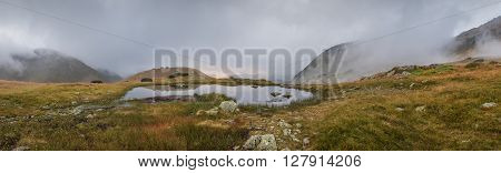 Wide Panoramic View of Small Tarn with Fog in West Tatra Mountains at Sunset
