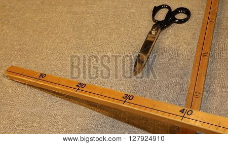 large tailor's scissors with the wooden meter in the Italian artisan tailoring