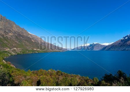 Lake Wanaka landscape with snow covered mountains. Winter mountain landscape with blue Wanaka lake. South Island, New Zealand