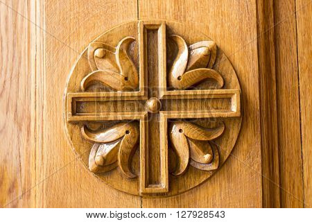 wood carving in the shape of a cross lacquering